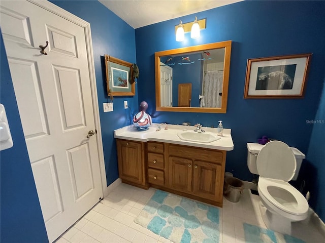 bathroom with tile patterned flooring, toilet, and vanity