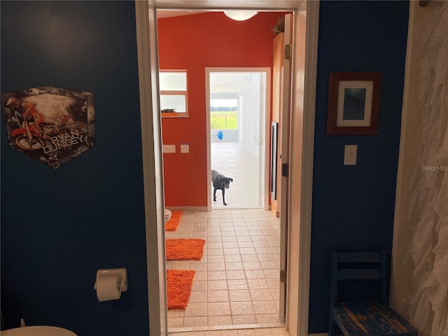 corridor featuring light tile patterned floors