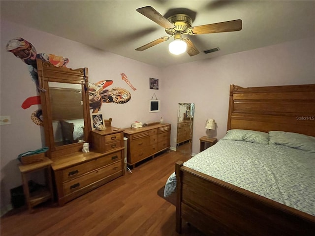 bedroom with dark wood-type flooring and ceiling fan