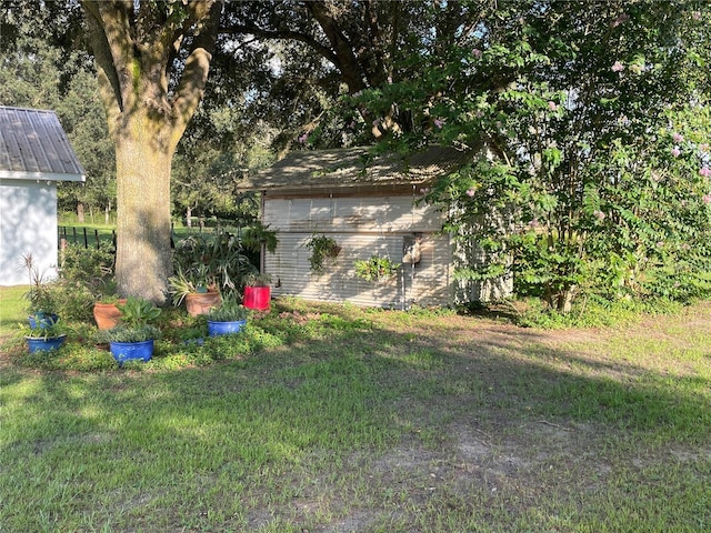 view of yard featuring a storage shed and an outdoor structure