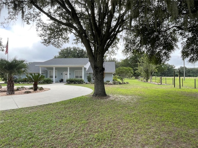 view of yard with driveway and fence