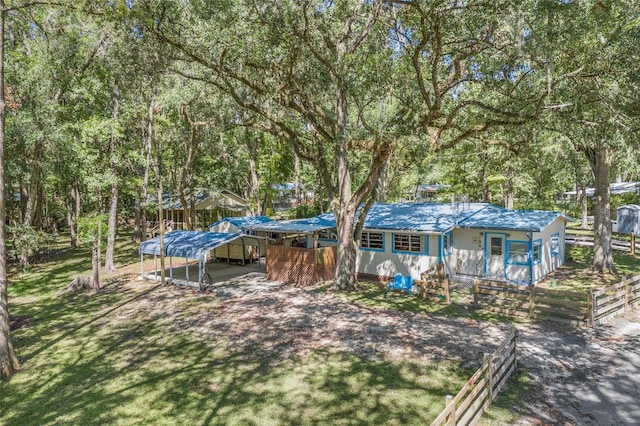 view of yard with a detached carport and fence