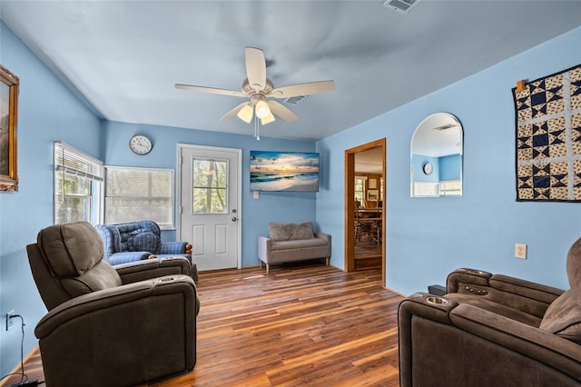 living area featuring a ceiling fan and wood finished floors