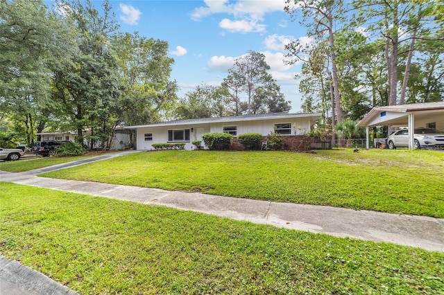 view of front of home featuring a carport, a front yard, driveway, and fence