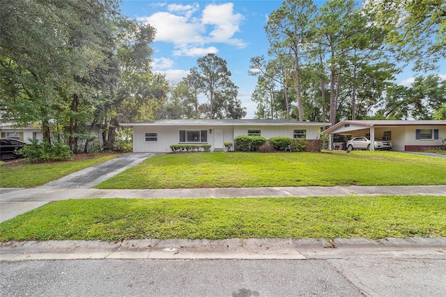 ranch-style home featuring concrete driveway, a front lawn, and an attached carport