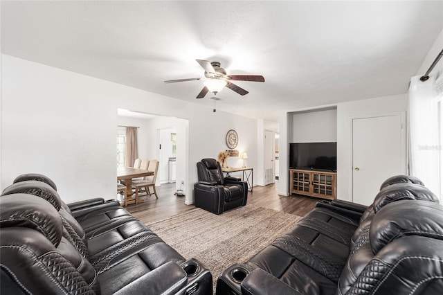 living room with ceiling fan and dark wood-style flooring