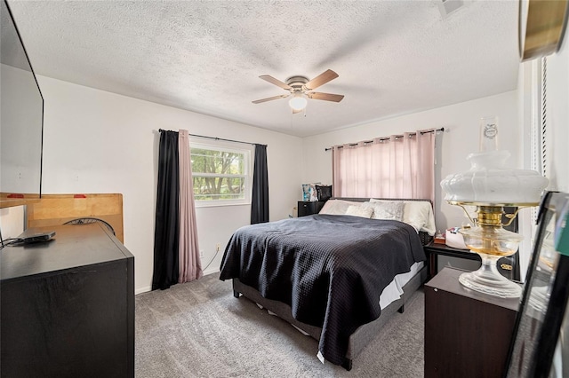 carpeted bedroom with ceiling fan, visible vents, and a textured ceiling