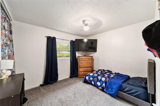 carpeted bedroom featuring ceiling fan, a textured ceiling, and baseboards