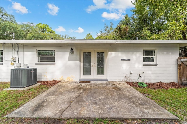 property entrance featuring french doors, central AC, and a patio