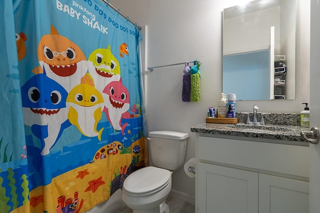 bathroom featuring vanity, a shower with shower curtain, and toilet