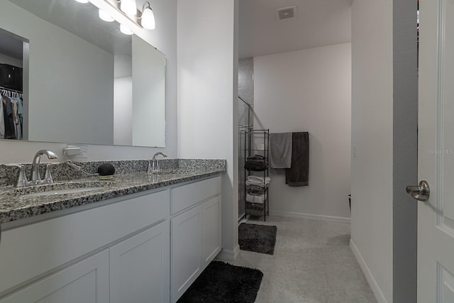 bathroom with tile patterned floors and vanity