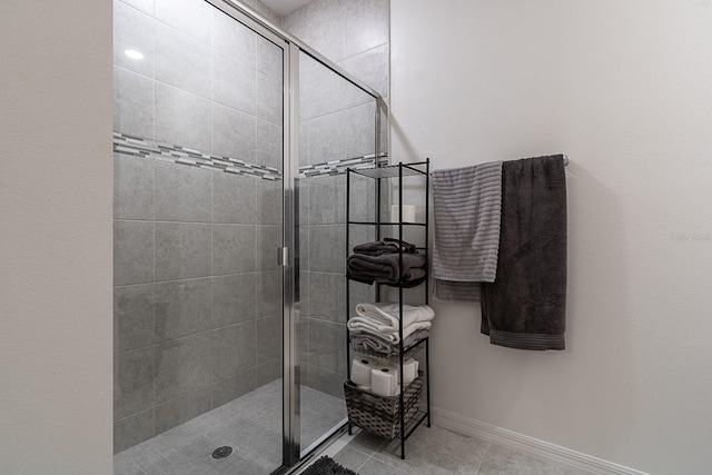 bathroom with tile patterned floors and walk in shower