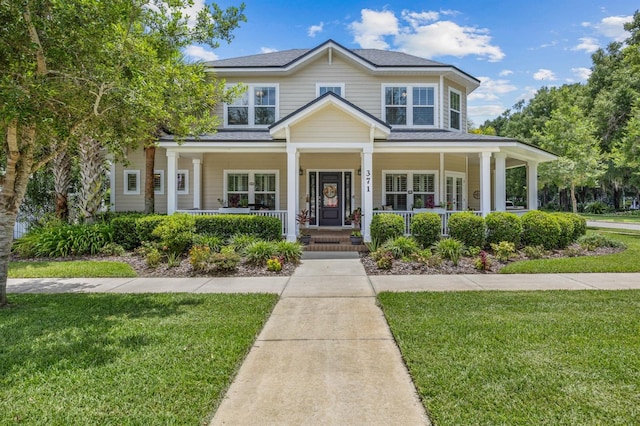 view of front of house with covered porch and a front yard