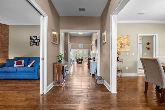 corridor with dark hardwood / wood-style flooring and ornamental molding