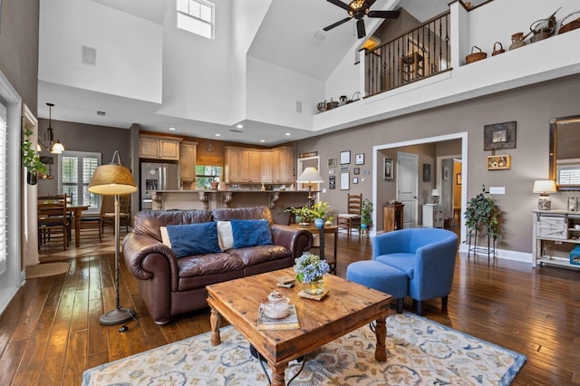 living room featuring ceiling fan, high vaulted ceiling, and dark wood-type flooring