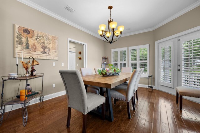 dining area featuring a chandelier, ornamental molding, and dark hardwood / wood-style floors