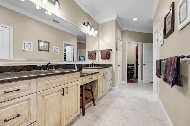 bathroom with crown molding, double sink vanity, and tile patterned flooring