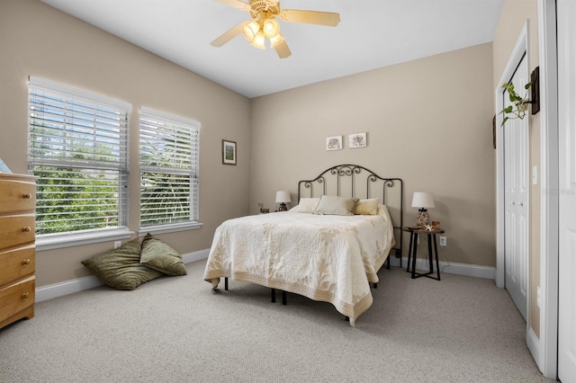 carpeted bedroom featuring ceiling fan and a closet