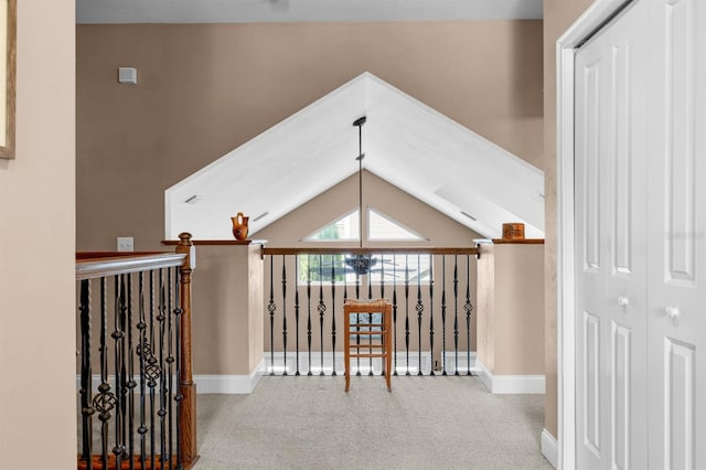 hallway featuring vaulted ceiling and carpet floors