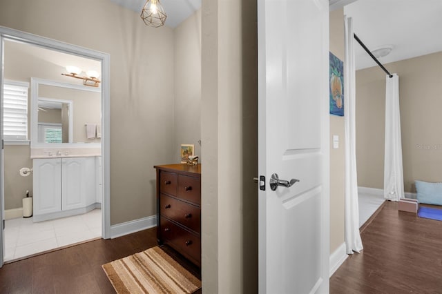 corridor featuring hardwood / wood-style flooring and sink