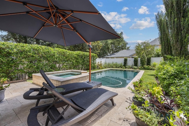 view of swimming pool with a patio area and an in ground hot tub