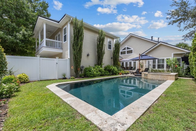 view of pool with a yard