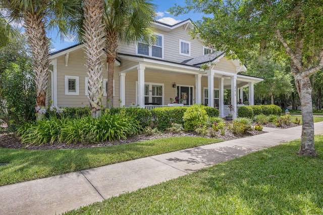 view of front of property featuring a porch and a front yard