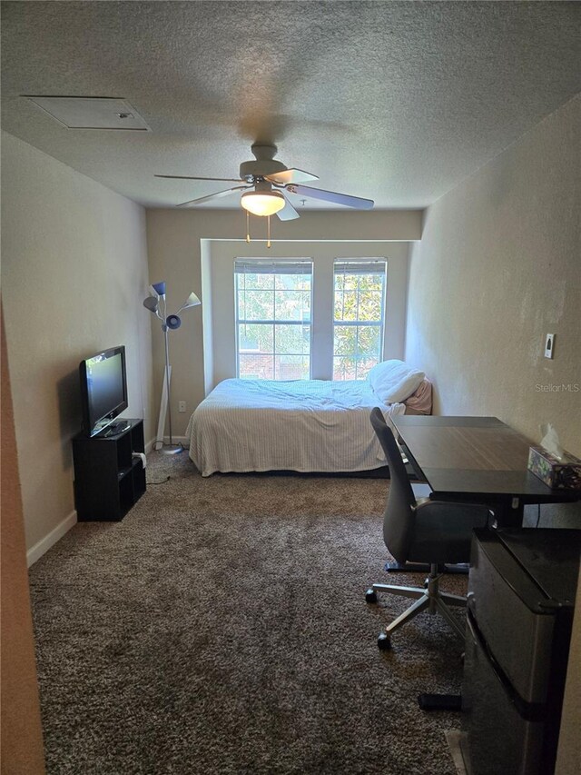 carpeted bedroom featuring a textured ceiling and ceiling fan