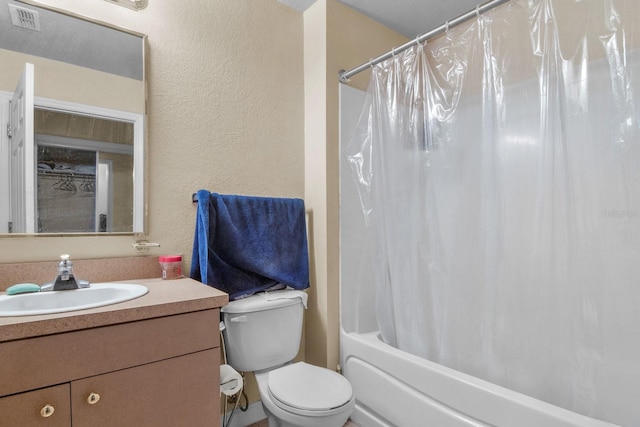 full bathroom with vanity, a textured wall, toilet, and shower / tub combo