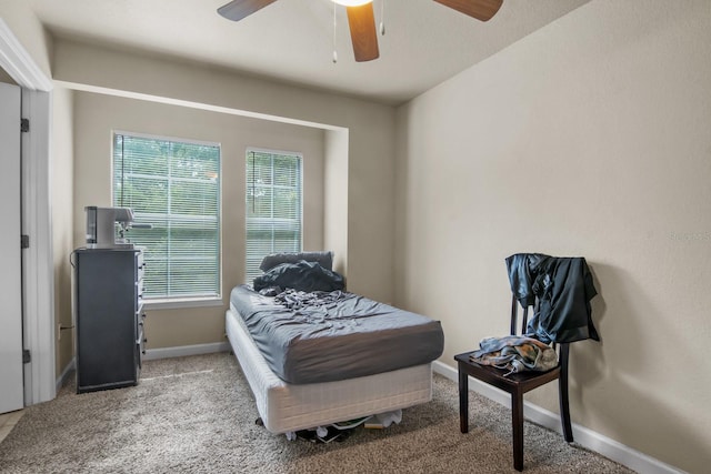 carpeted bedroom featuring baseboards and ceiling fan