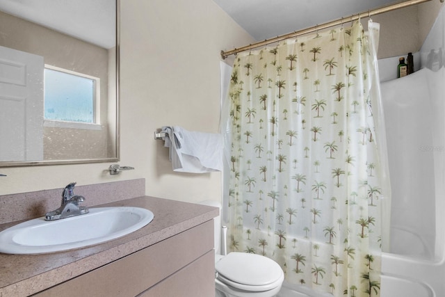 bathroom featuring toilet, shower / tub combo, and vanity