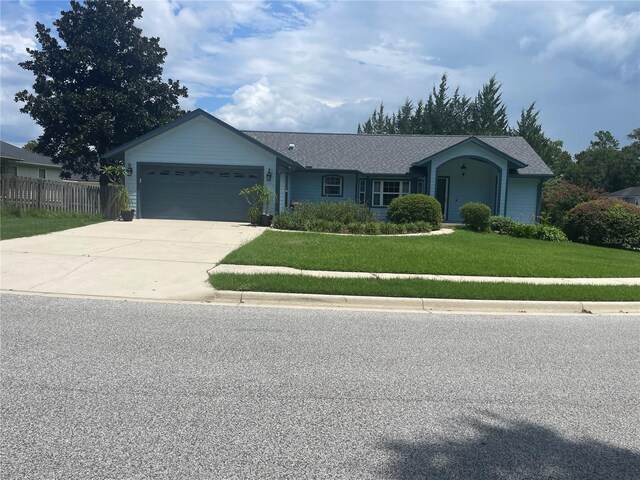 ranch-style home with a front yard and a garage