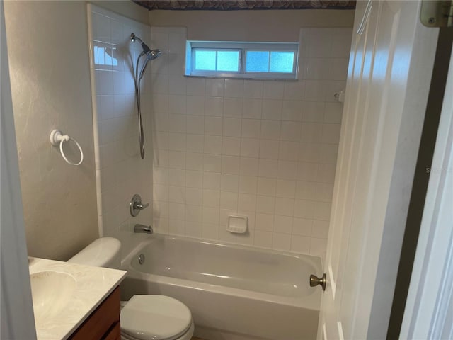 full bathroom with tiled shower / bath combo, vanity, and toilet