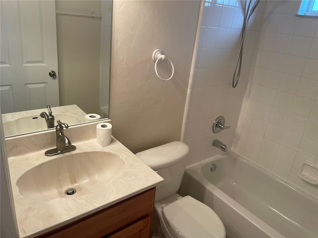 full bathroom with tiled shower / bath combo, vanity, and toilet