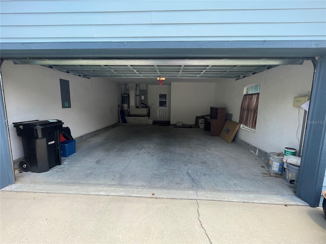 garage featuring electric panel and water heater