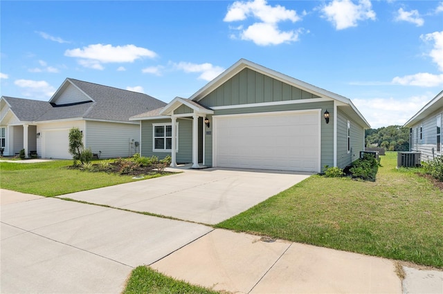 view of front of property featuring central AC unit, a garage, and a front lawn