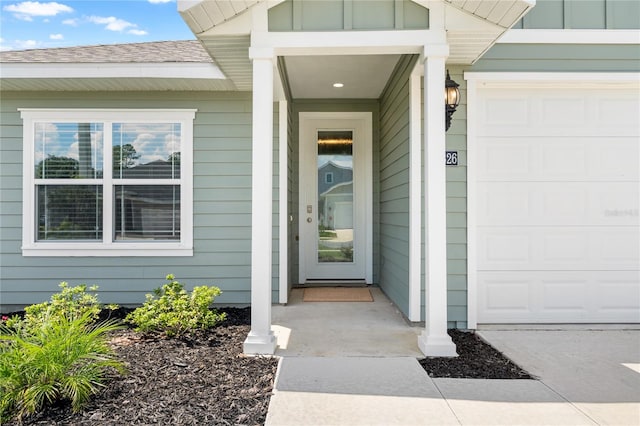 doorway to property with a garage