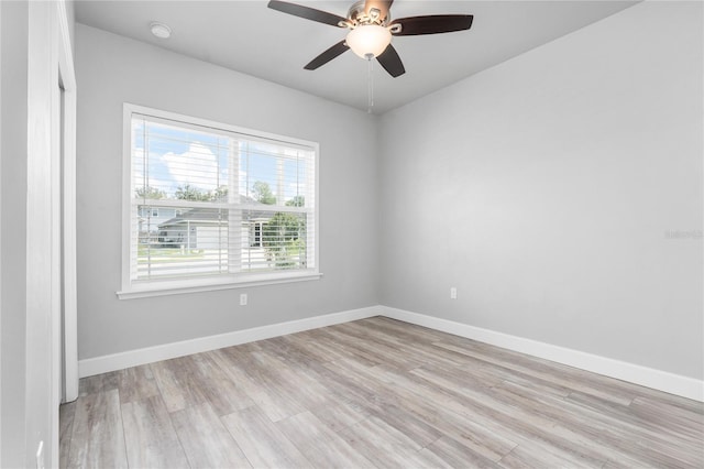 empty room with ceiling fan and light hardwood / wood-style floors