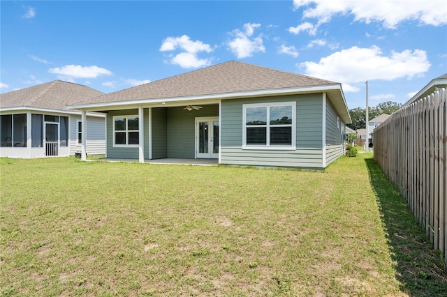 rear view of property featuring a patio area and a lawn