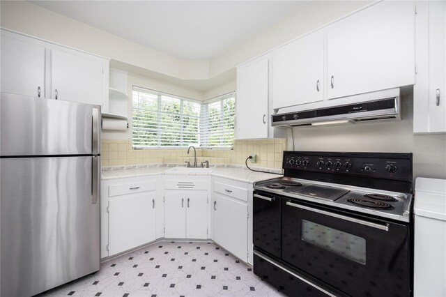 kitchen featuring black range with electric stovetop, extractor fan, stainless steel refrigerator, light tile patterned floors, and sink