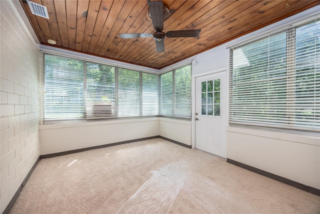 unfurnished sunroom featuring wooden ceiling, visible vents, and a ceiling fan