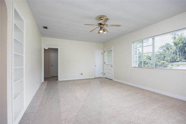 unfurnished room featuring ceiling fan and light colored carpet