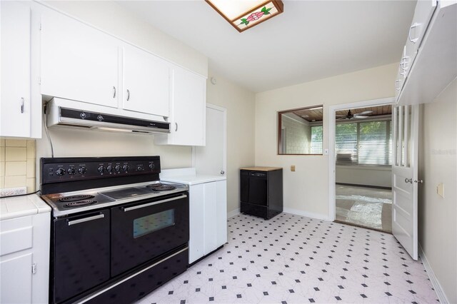 kitchen with custom range hood, white cabinets, black / electric stove, tile counters, and light tile patterned flooring