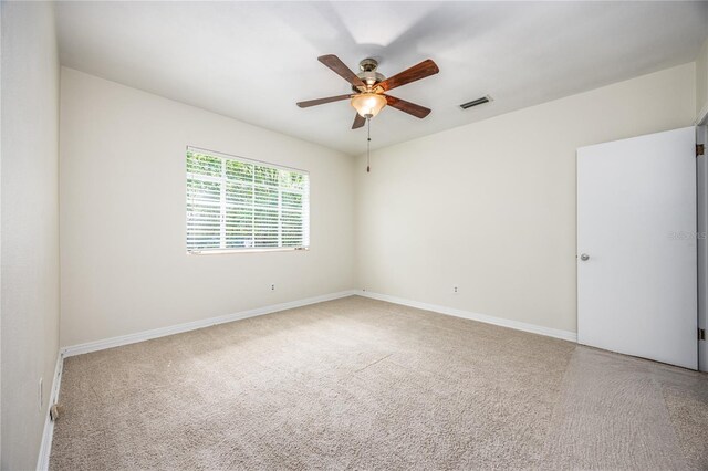 unfurnished room featuring ceiling fan and carpet