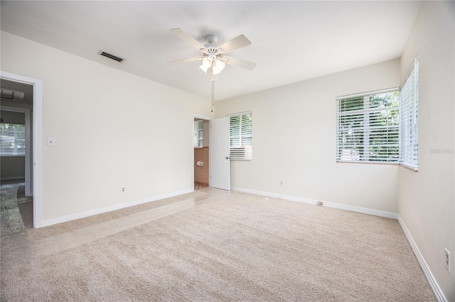 unfurnished room featuring a ceiling fan, carpet flooring, visible vents, and baseboards