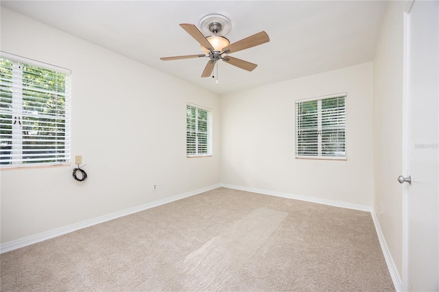 unfurnished room featuring carpet floors, baseboards, and a ceiling fan