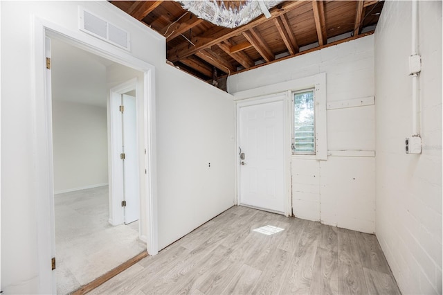 interior space with light wood finished floors and visible vents