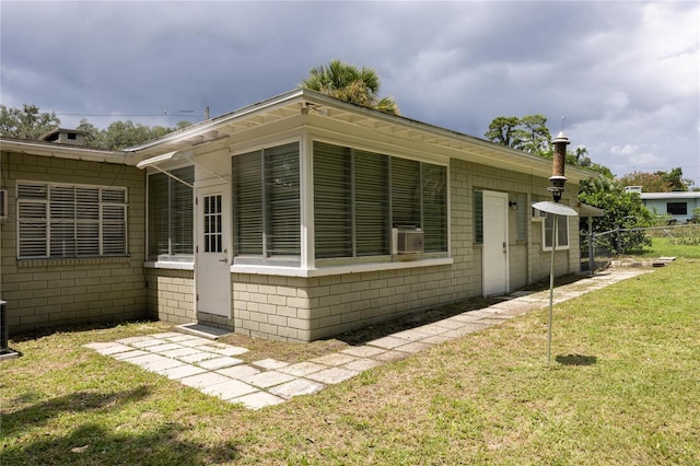 view of property exterior with a yard and fence