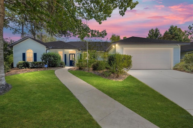 ranch-style house with a garage, driveway, and a front yard