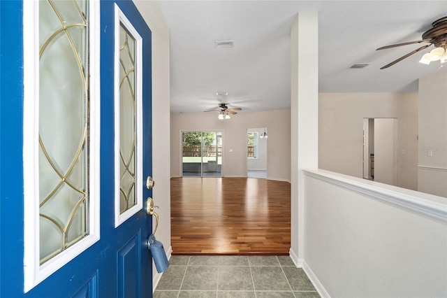 entrance foyer featuring ceiling fan and tile patterned floors